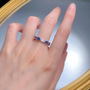 Macro detail of S925 silver ring featuring blue marquise-cut stones and a white crystal