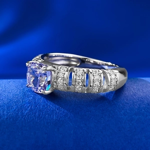Macro side view of silver ring with square purple stone and hollowed band details