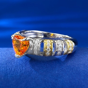 Macro shot of s925 silver heart orange stone ring with dual-tone metal and fine engraving