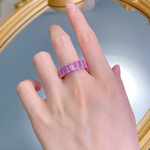 Close-up of 925 silver ring with rectangular pink sapphires worn on a finger