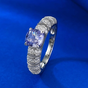 S925 sterling silver ring with purple cushion-cut gem and diamond accents on a blue background