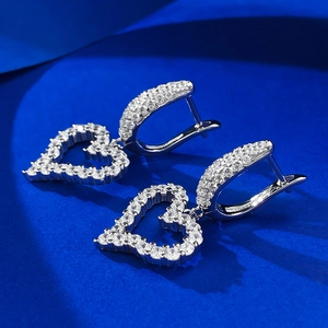 Macro shot of silver S925 heart earrings with micro-pave cubic zirconia stones