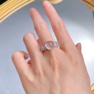 Close-up of a silver ring with a lavender jade cabochon on a hand for proportion