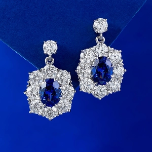 Elegant S925 silver earrings with 6x8mm oval tanzanite blue stones and diamond halo