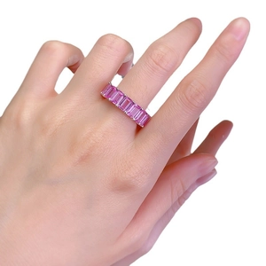 Eternity band with rectangular pink sapphire stones set in 925 silver on finger