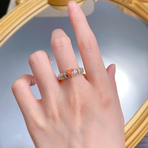 Close-up of S925 silver heart orange Fanta stone ring with pavé stones on hand