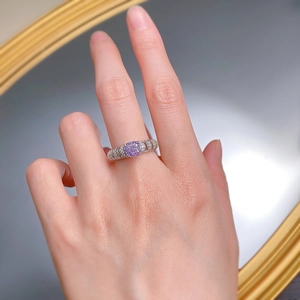Close-up of a s925 silver ring featuring a purple oval-cut high carbon diamond on finger