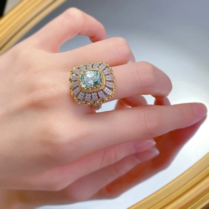 Close-up of S925 silver cocktail ring with green gemstone and vintage gold setting