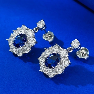 Macro shot of S925 sterling silver stamp on blue oval halo earrings with cubic zirconia