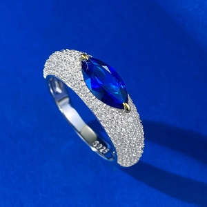Detailed view of the S925 silver stamp on a blue marquise-cut gemstone ring