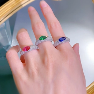 Detail of S925 silver marquise-cut rings in red, green and blue with pavé diamonds