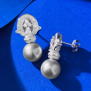 Detail shot of 925 silver 11mm grey pearl earrings with intricate diamond-encrusted design