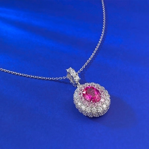 Luxurious oval rubellite pendant with double halo diamond setting on silver chain