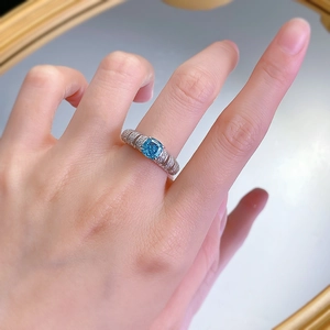 Detailed macro view of a 925 silver ring featuring a square Paraiba blue gemstone