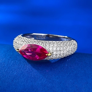 Macro shot of S925 silver ring with marquise red stone and pavé-set zircons details