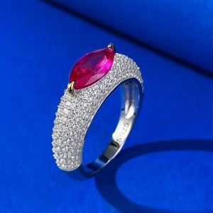 Detailed macro of S925 silver marquise ring with red ruby stone and gold prongs