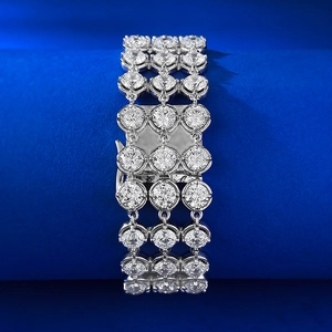 Three-row sparkling zircon tennis bracelet with silver finish on a blue display stand