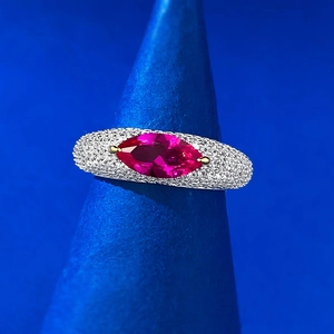 Macro detail of S925 silver ring featuring horizontal marquise red gem and pavé diamonds