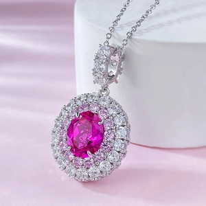 Close-up of pink oval gemstone pendant with double halo diamond-like inlay settings