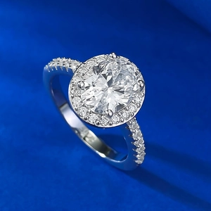 Elegant S925 silver ring featuring an oval halo crystal and pavé side stones on blue velvet
