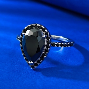 Retro 925 silver ring featuring a pear-cut black zircon stone on a blue background