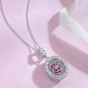 Macro shot of oval rose pendant necklace with pink gemstone and silver metal detail