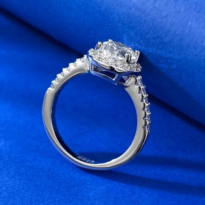 925 silver halo ring with oval cut gemstone and side stones on blue velvet base