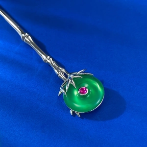 Elegant silver bamboo joint hair stick with a large green stone and red gemstone accent