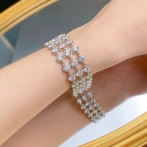 Detailed view of luxury triple-row silver bracelet with shimmering round-cut crystals