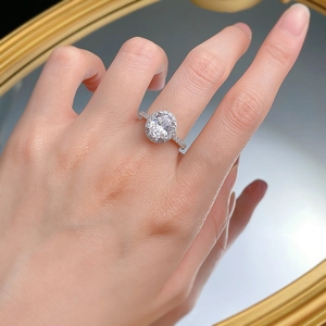 Close-up of 925 silver oval halo ring with sparkling carbon diamond on model's hand