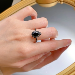 Macro shot of 925 silver pear-shaped black zircon ring with rose gold plating