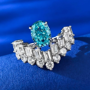 Macro view of oval Paraiba tourmaline ring with baguette cut stones on velvet