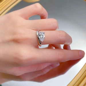 Close-up of a pear-cut 2-carat diamond ring with a minimalist S925 silver bypass band