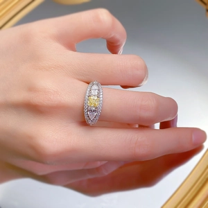 Macro shot of an S925 silver ring featuring a yellow square gem and pear-cut side stones