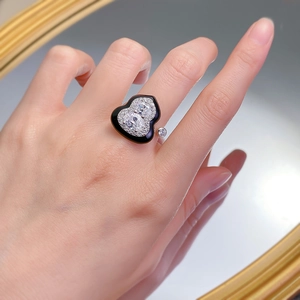 Macro shot of s925 silver open ring with black enamel wulu charm and inlaid zircons