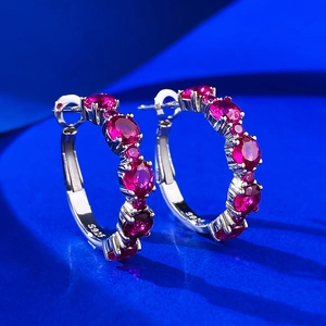 Luxurious S925 sterling silver hoop earrings with full pink pavé stones on blue backdrop
