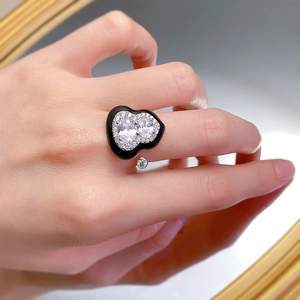 Macro detail of silver wulu ring with black enamel and sparkling cubic zirconia stones