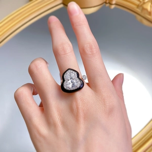 Detailed close-up of a hollow gourd-shaped ring with black enamel and micro-pave zircons