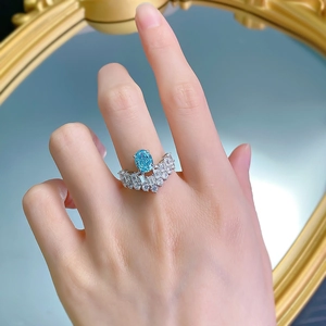 Detail of 925 silver ring with blue paraiba stone in crown setting on hand