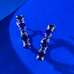 S925 sterling silver drop earrings featuring five blue sapphires in claw settings