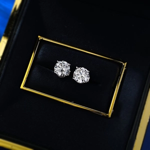 Close-up of 1ct round brilliant cut silver stud earrings in a luxury black velvet gift box