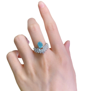 925 silver ring with oval paraiba blue stone and crown diamond setting on hand