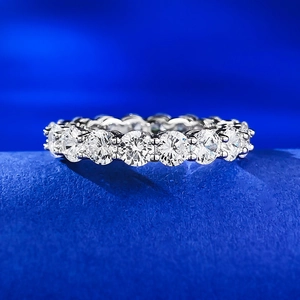 Eternity S925 silver ring with 4mm round-cut sparkling crystals on blue velvet