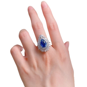 Luxurious 925 sterling silver ring with large pear-shaped blue stone and white crystals