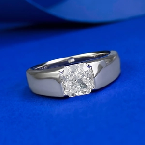 Macro shot of 925 silver ring with cushion cut carbon diamond on blue background