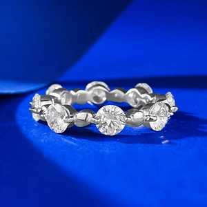 Minimalist S925 sterling silver beaded ring with sparkling round zircons on blue texture