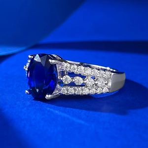 S925 sterling silver ring featuring a large oval blue gemstone with halo diamonds