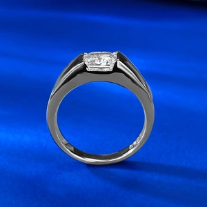Macro shot of S925 sterling silver ring with square-cut carbon diamond on blue fabric