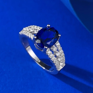 Elegant S925 silver ring featuring a large oval blue gemstone and zircon pave setting
