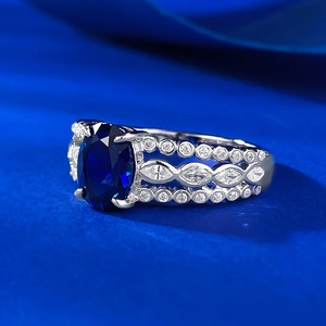 Elegant silver ring featuring oval blue sapphire and triple-row zircon hollowed band